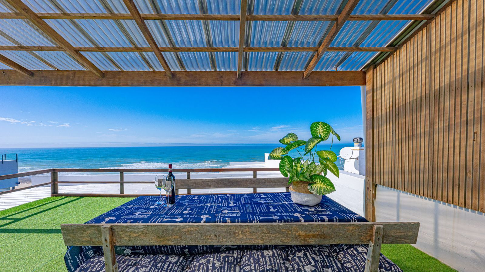 Whale Watchers — covered balcony with outdoor table and ocean view
