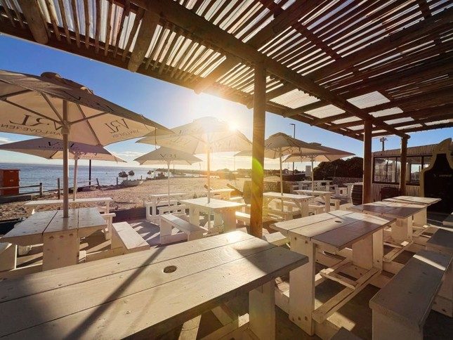 Beachfront café seating overlooking the ocean